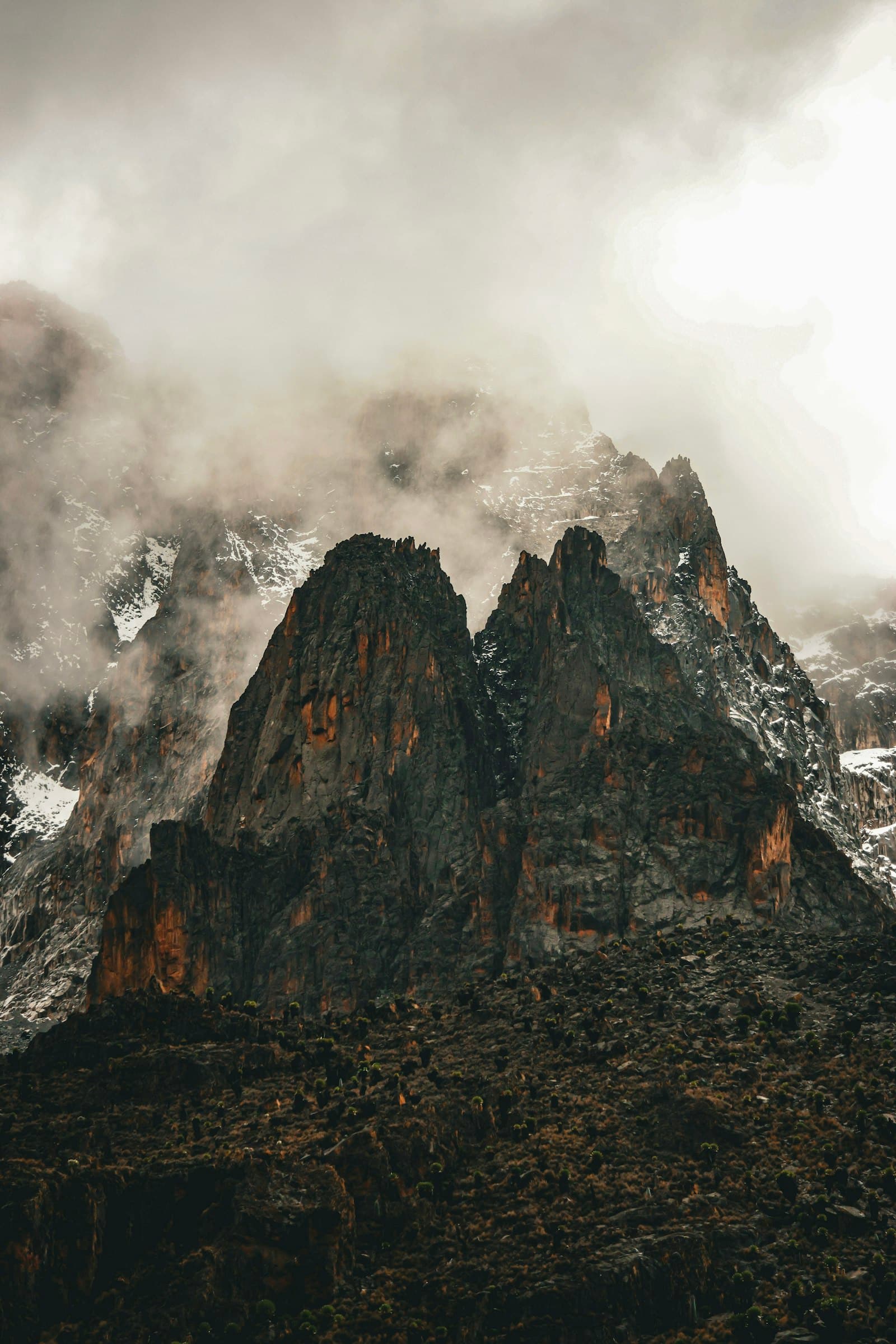 Jagged rock peaks of Mount Kenya - Nelion and Batian - shrouded in cloud and mist