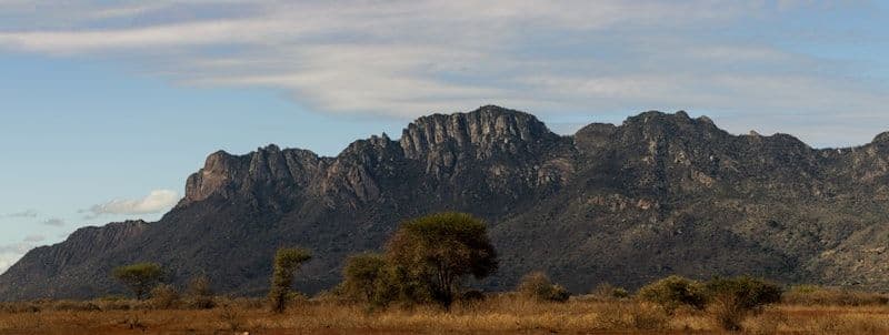 Rocky highland moorland with brown mountain slopes under wide open sky — Naro Moru route